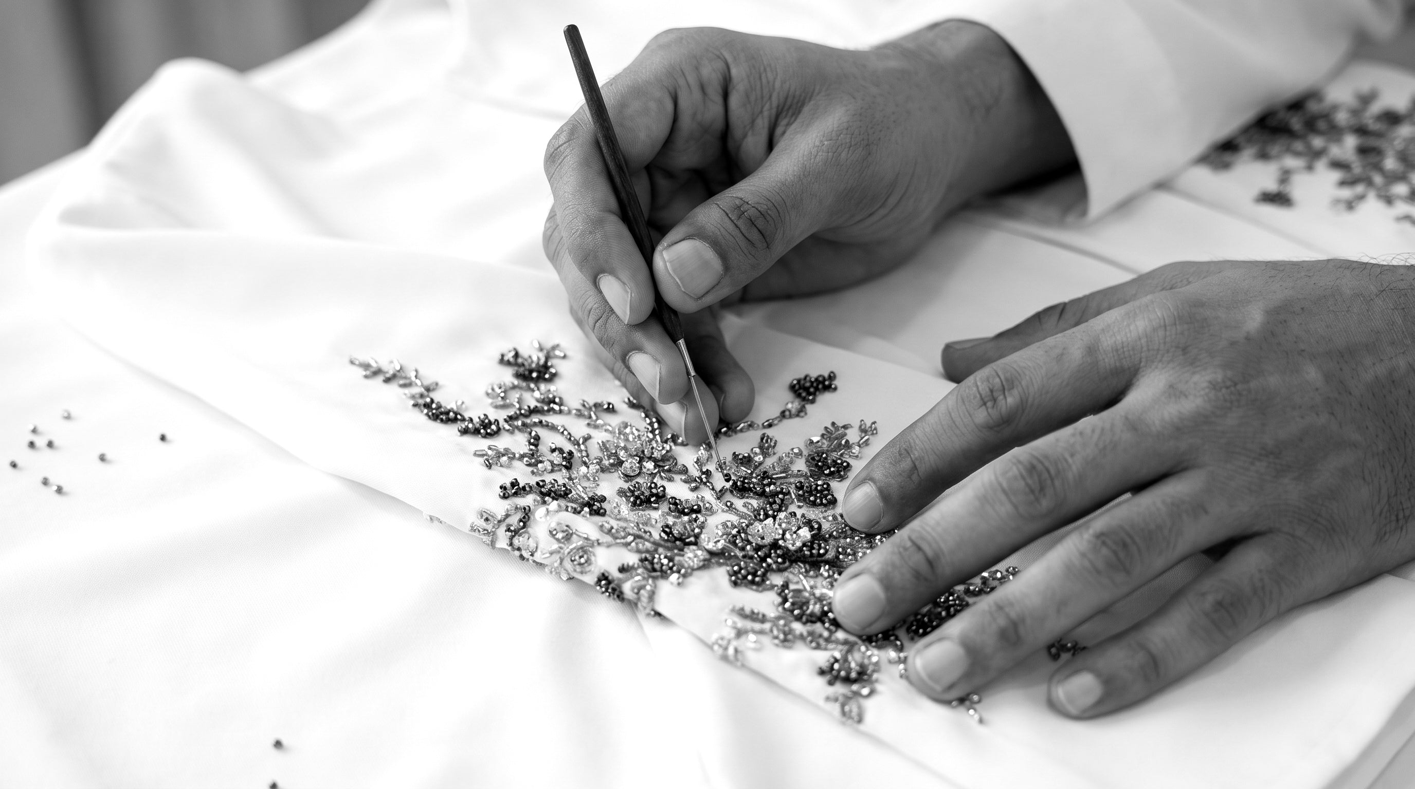Beadwork being applied by hand in the Atelier Ahad Dubai atelier